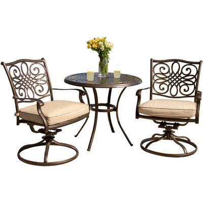 Hanover Traditions 3-Piece 33" Round Cast Top Bistro Set with Swivel Rocker Chairs - Tan | TRADITI3PCSW