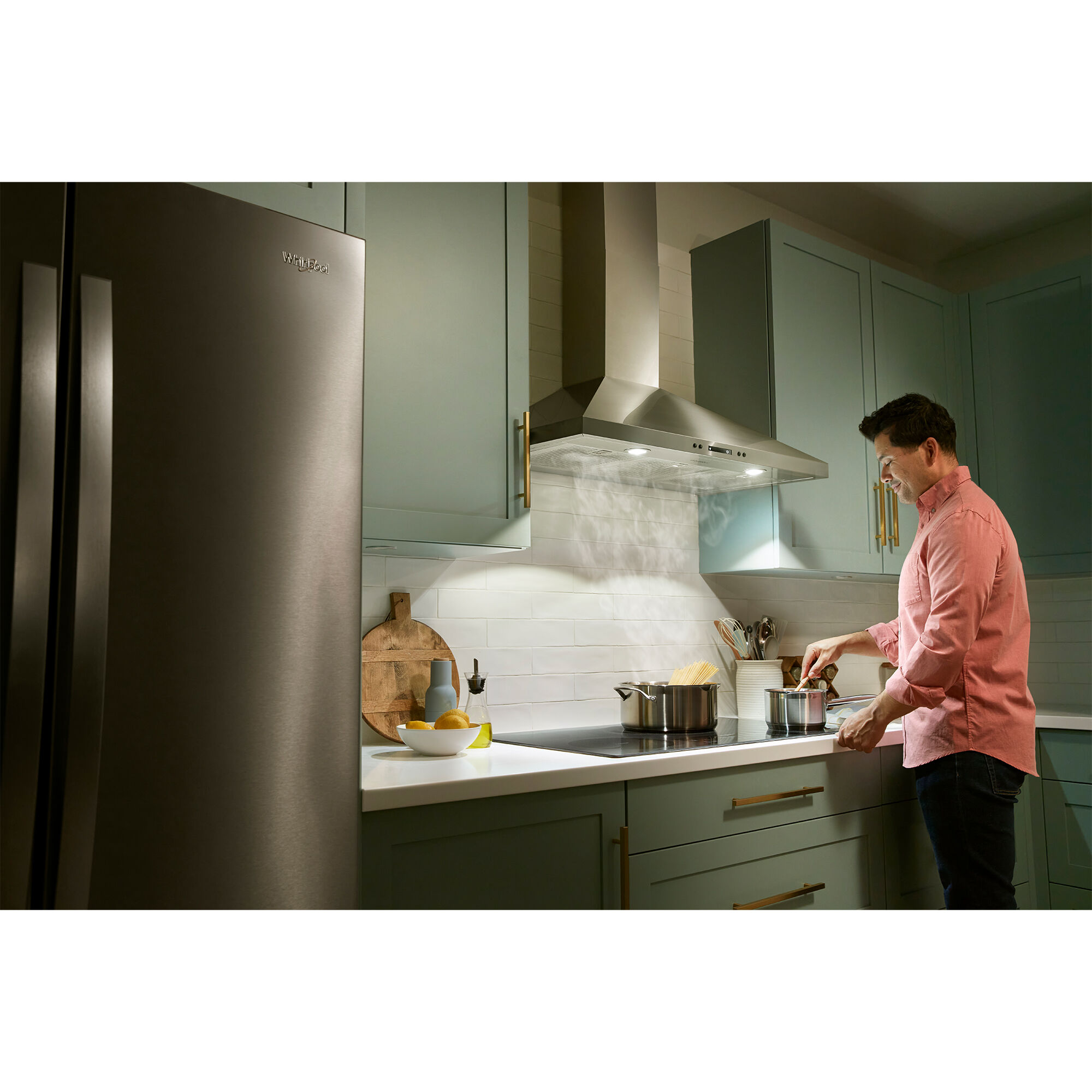 Whirlpool WVW93UC0LZ range hood with dual LED lights illuminating a cooktop surface below.