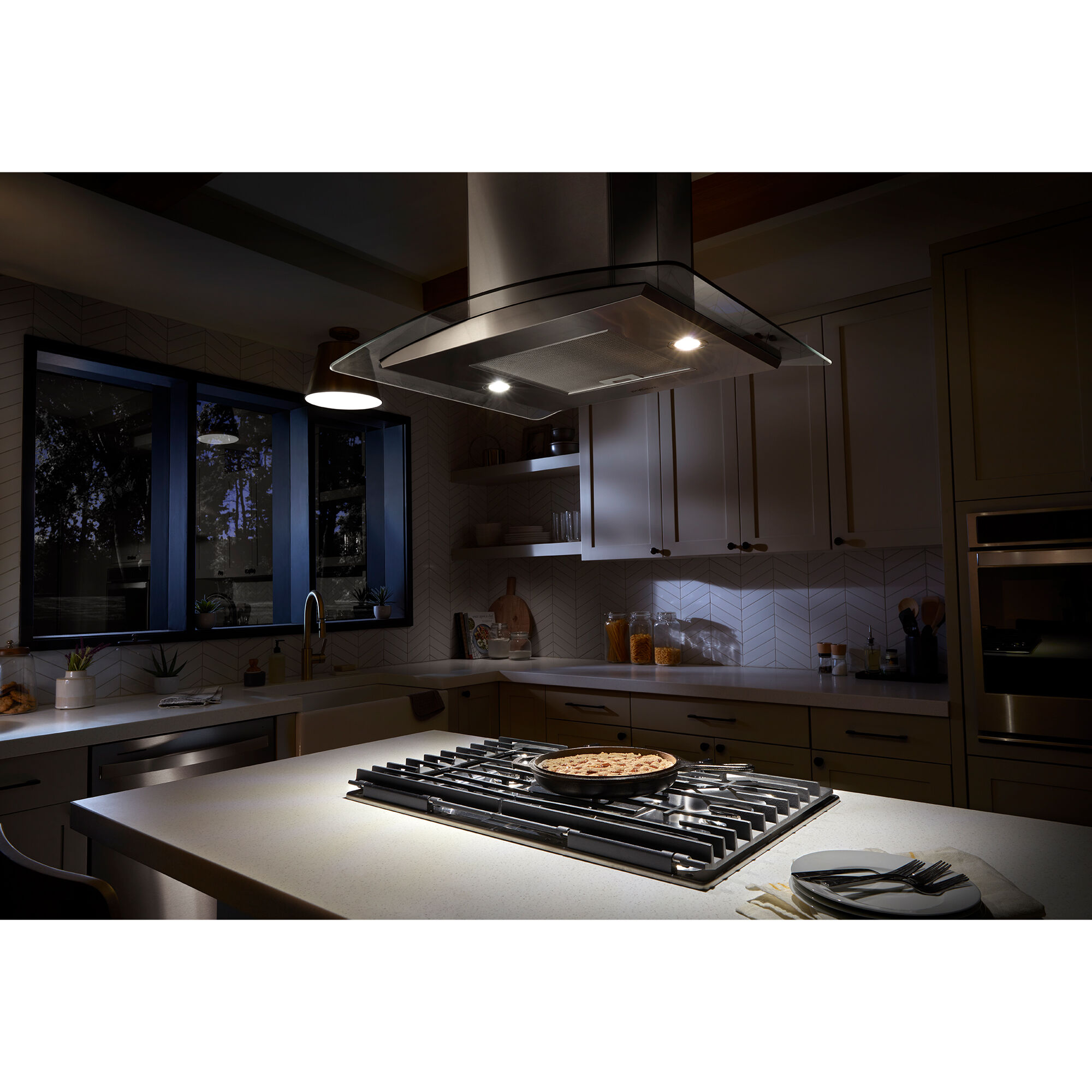 Whirlpool WVW53UC0LS range hood with LED cooktop lighting illuminating the cooking surface below.
