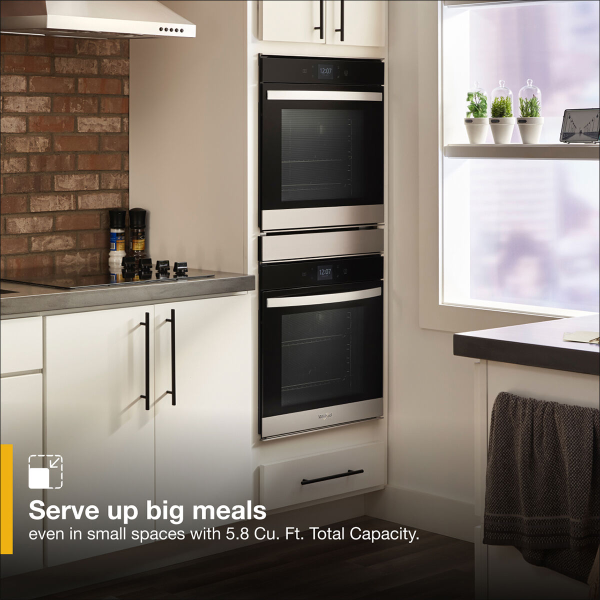 Whirlpool WOD52ES4MZ 24-inch double wall oven installed in a modern kitchen with creme colored finished cabinetry.