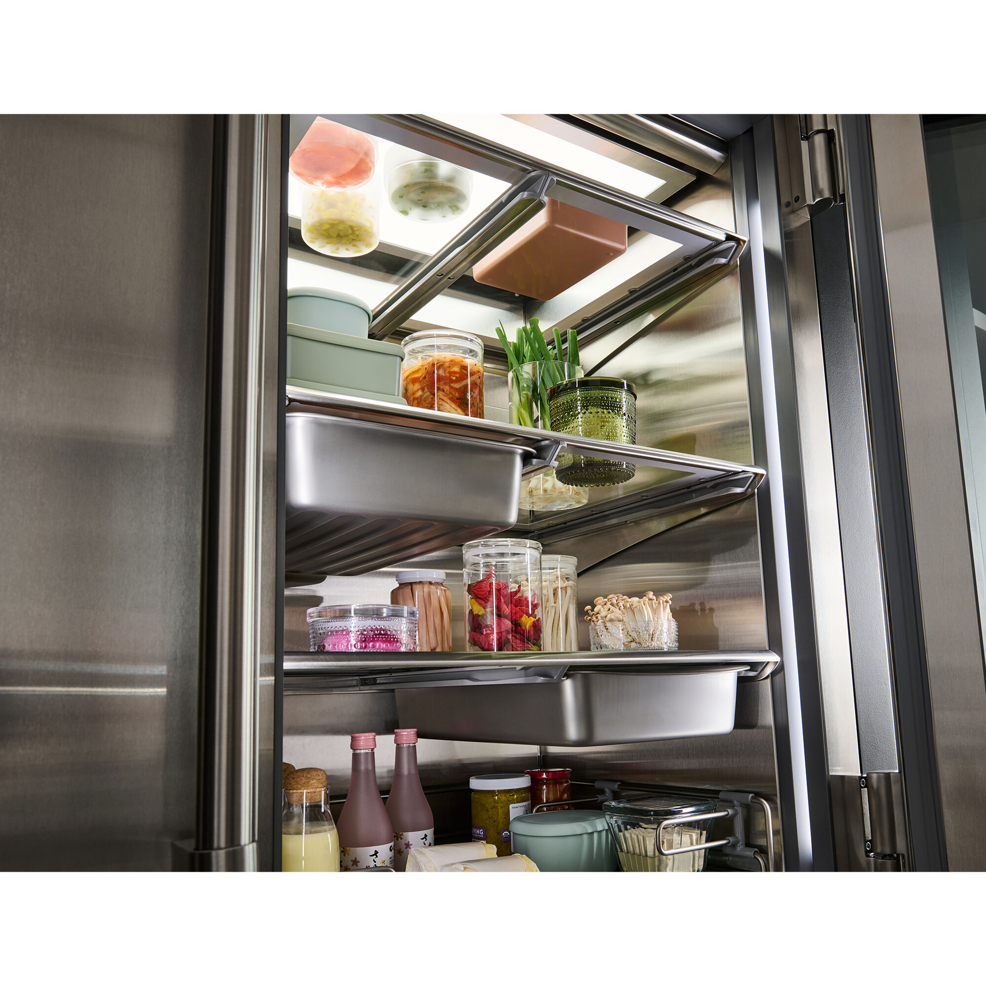 Interior view of Sub-Zero PRO4850G showing dual refrigeration compartments, glass door, and organized shelving