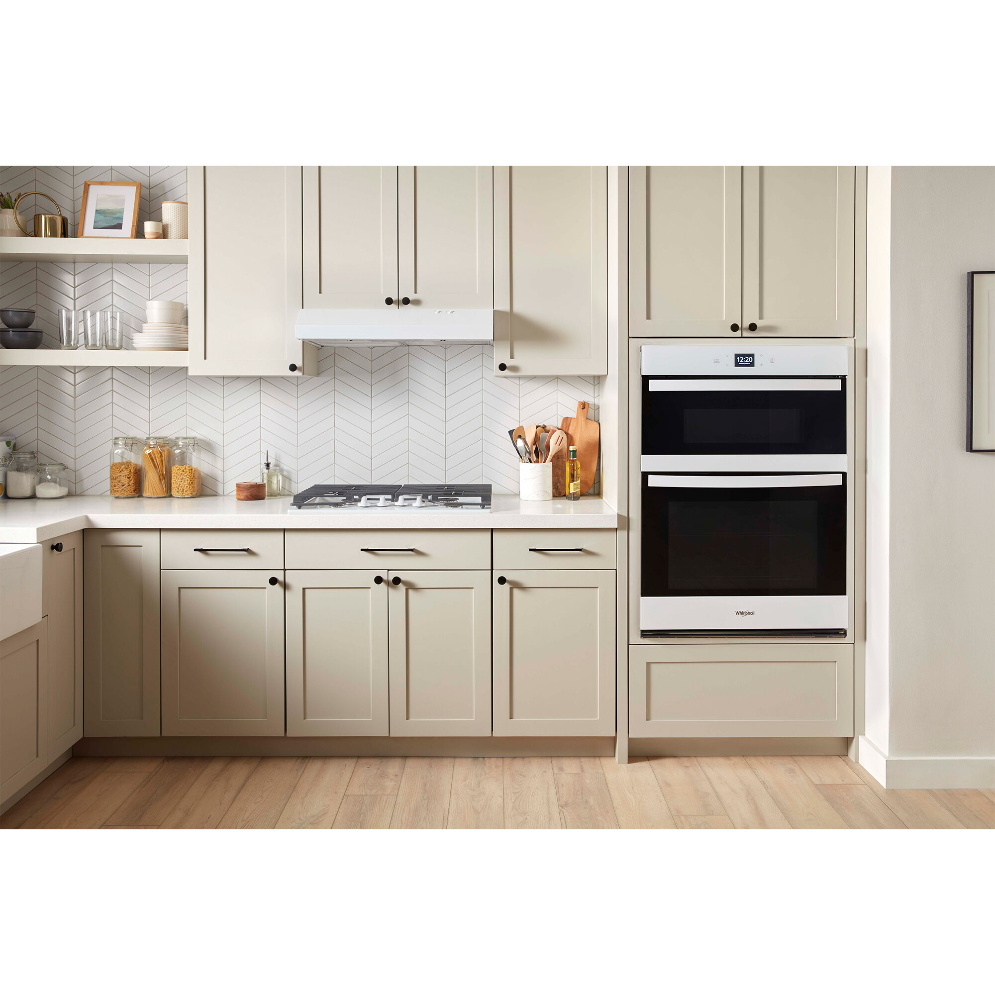 Whirlpool WOEC5030LW combo wall oven and microwave installed in a modern creme colored kitchen, showing the integrated design.