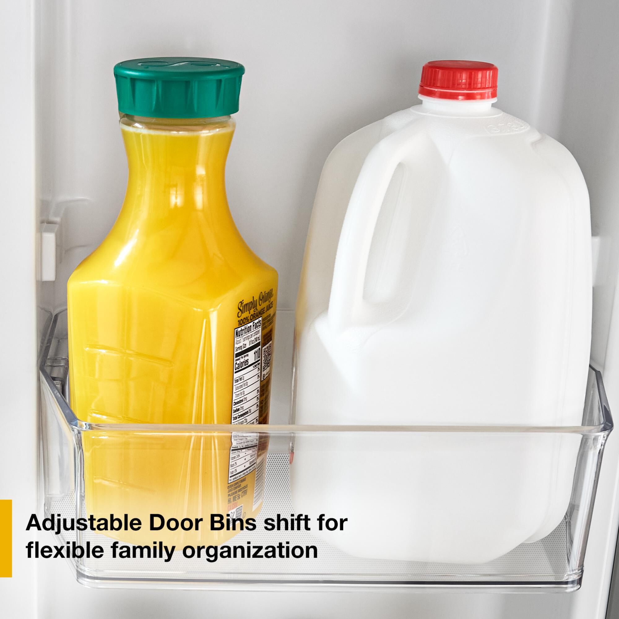 Whirlpool WRTX5519SZ door with adjustable clear bin holding a juice carafe and milk jug, showing flexible storage for tall family-size containers.