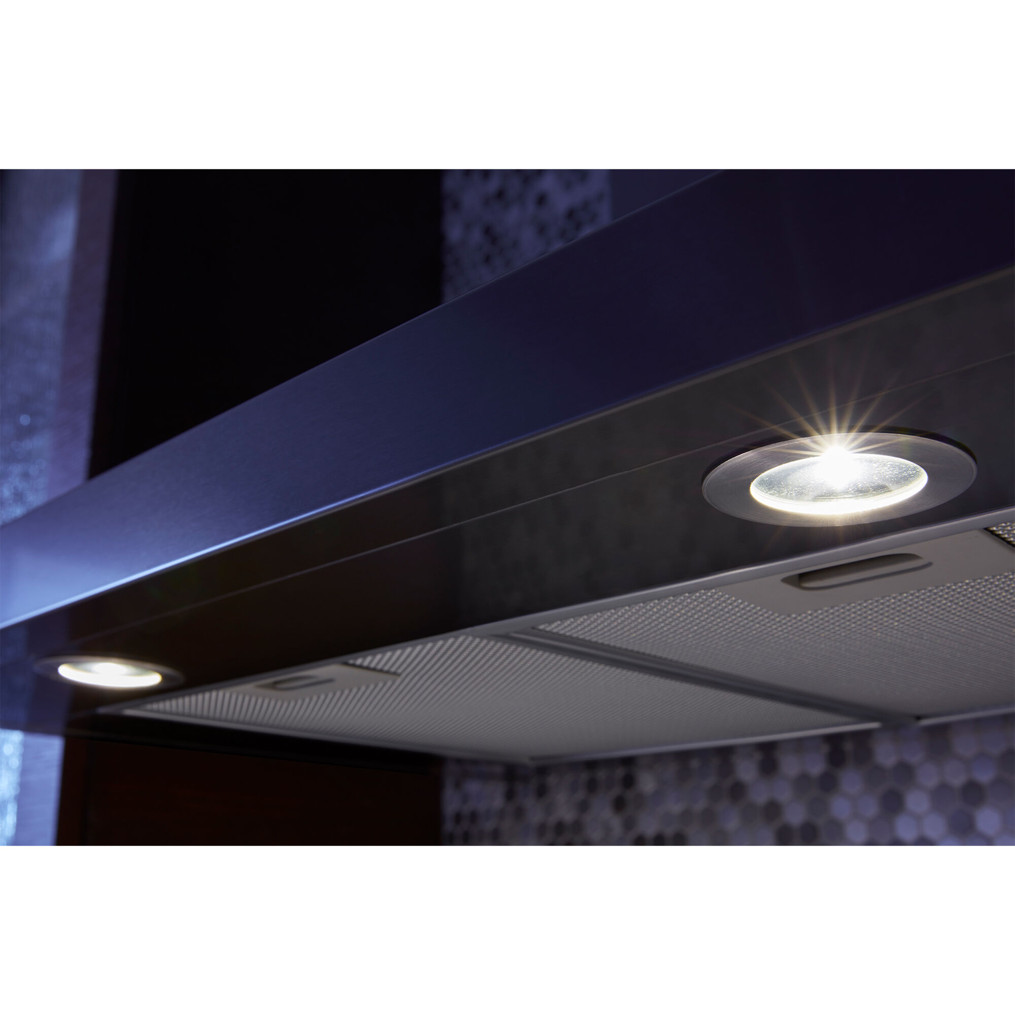 Underside of Whirlpool WVW53UC0HV range hood showing two LED lights illuminating a cooktop surface below.