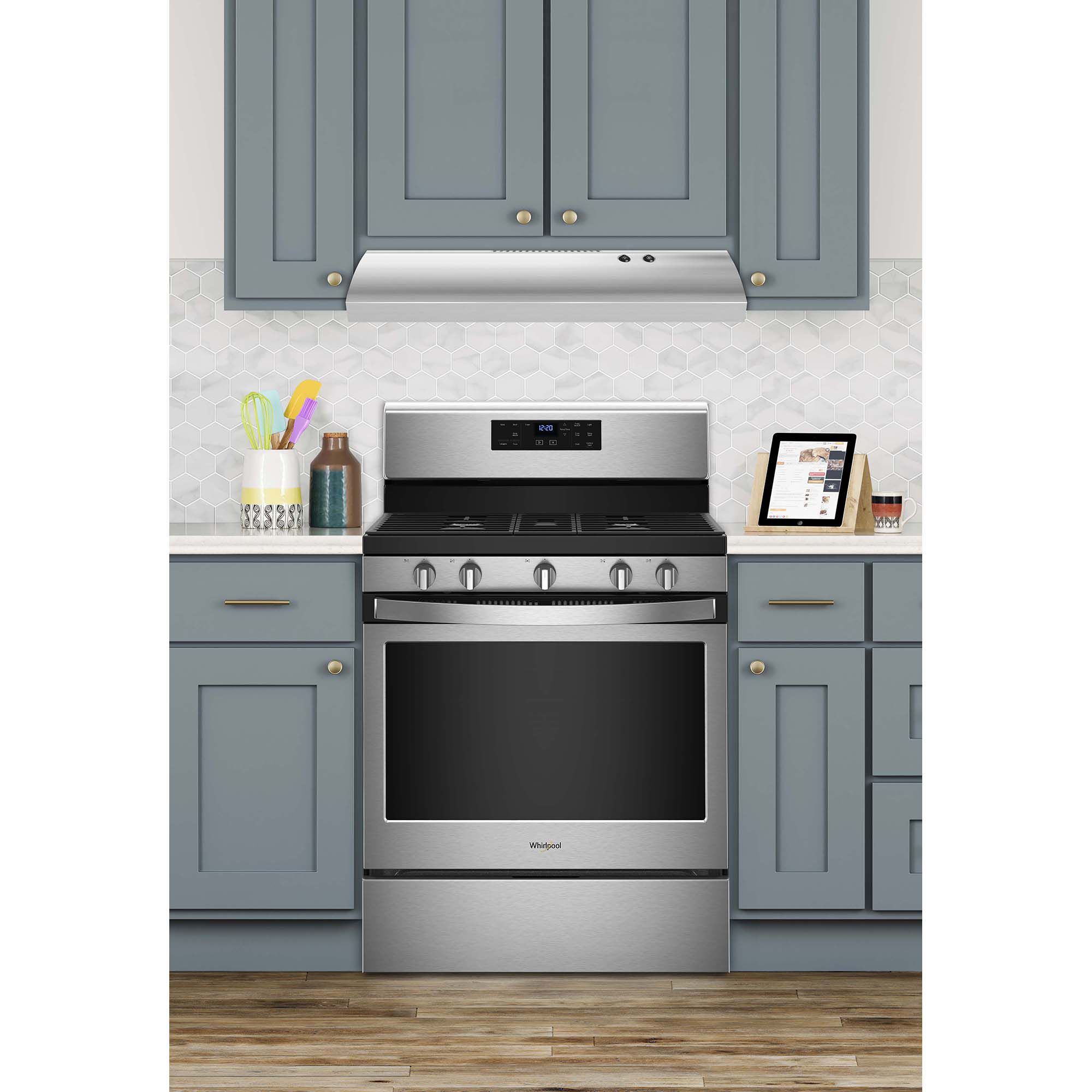 Whirlpool UXT4030ADS stainless steel under-cabinet range hood installed above a kitchen range in a modern kitchen.