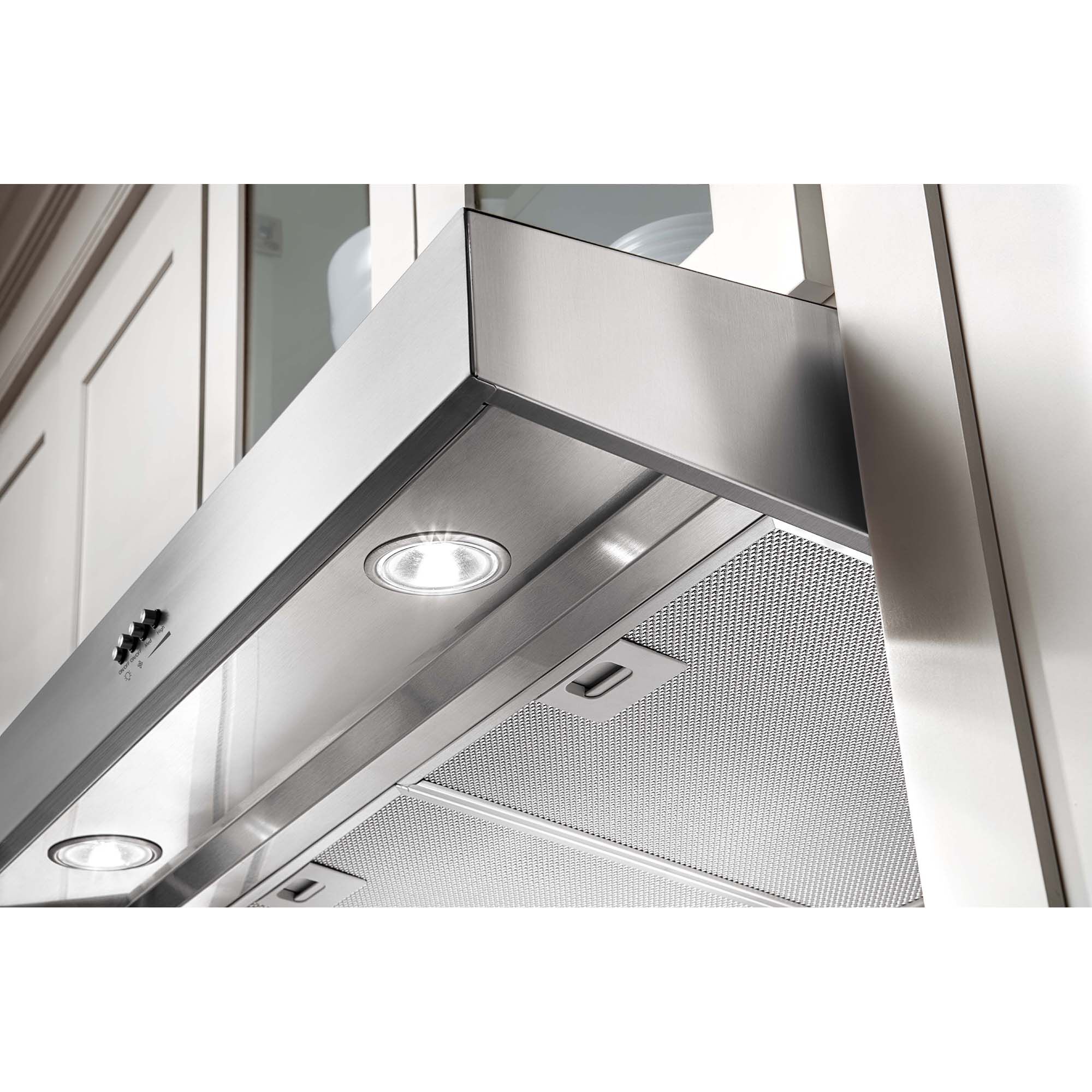 Whirlpool WVU37UC0FS under-cabinet range hood with cooktop light illuminating the cooking surface below.