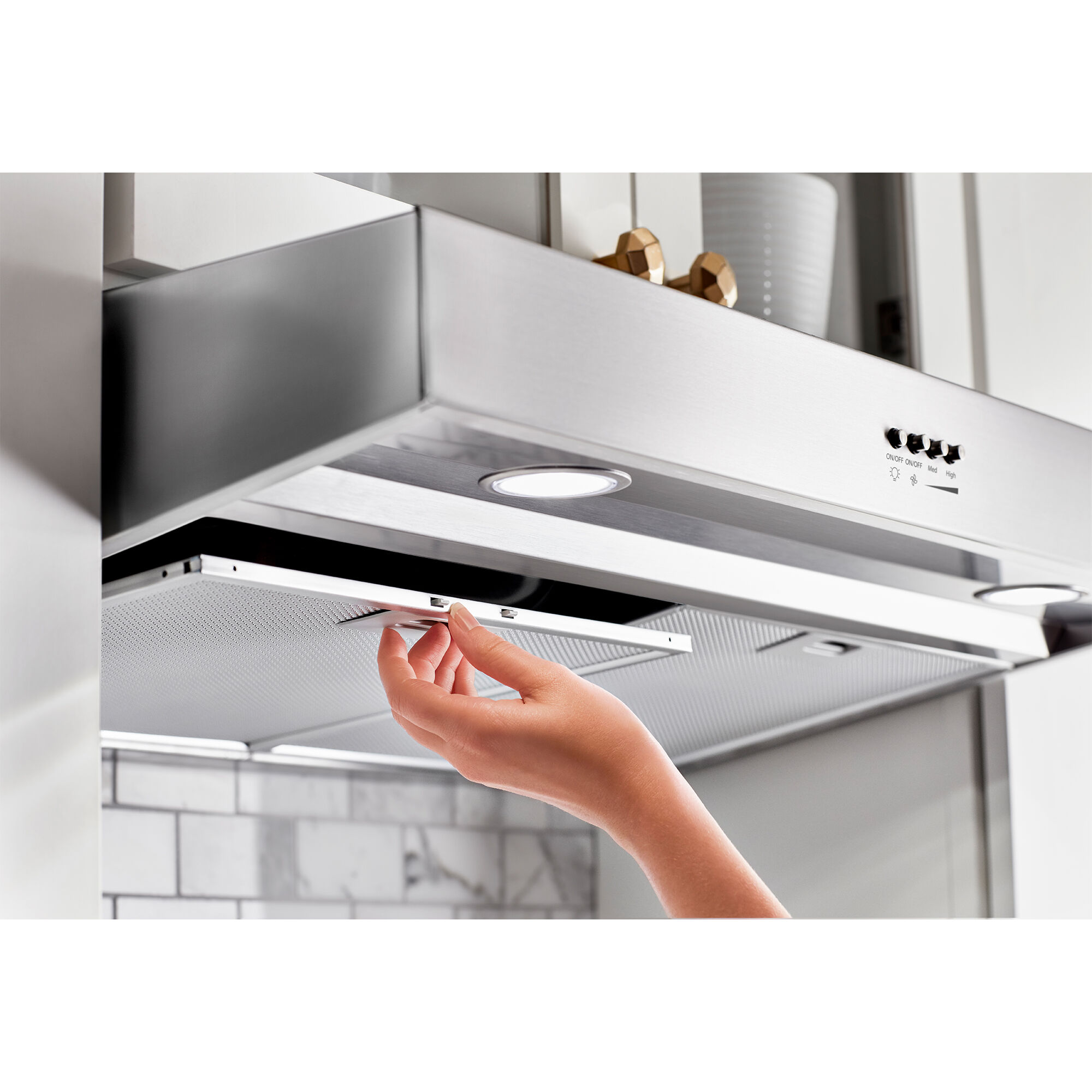Whirlpool WVU37UC6FS 36-inch under-cabinet range hood in stainless steel finish shown installed above a range.