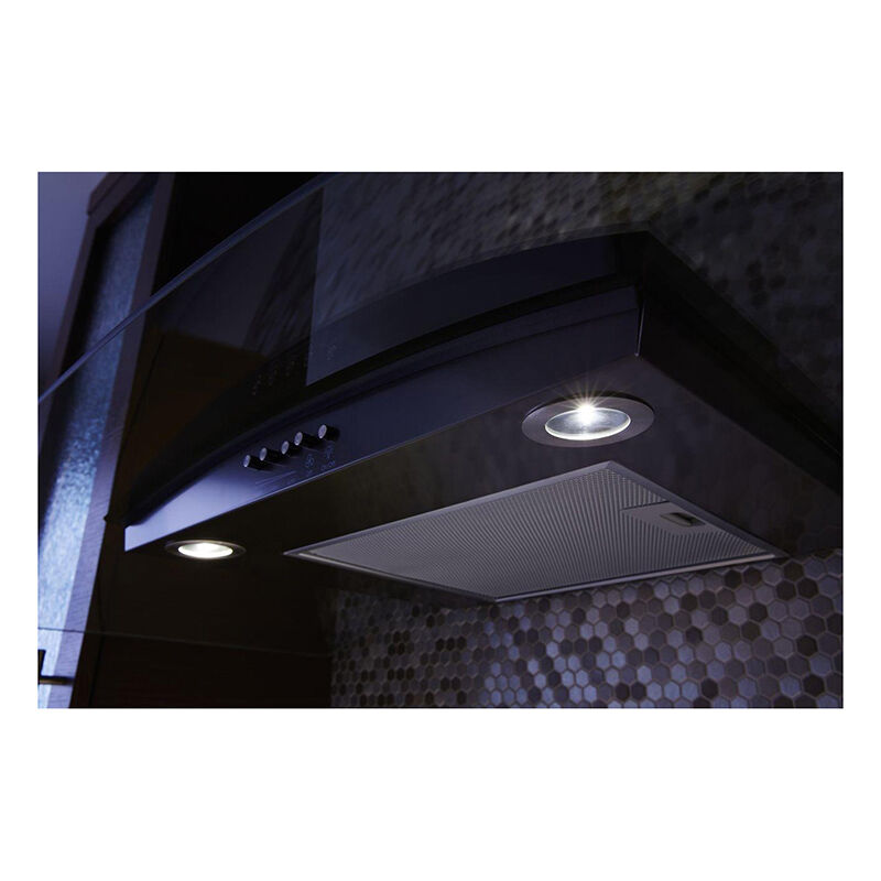 Whirlpool WVW51UC0HV range hood LED lights illuminating the cooktop surface below in a modern kitchen.