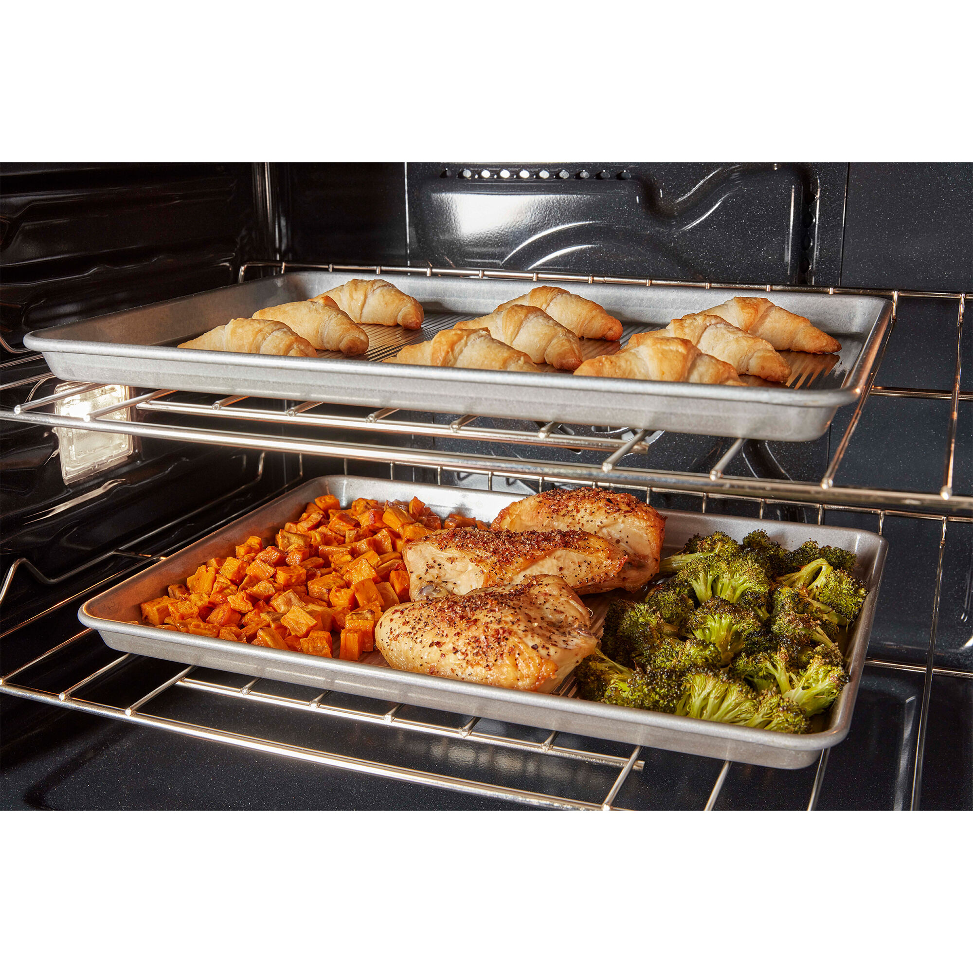 Interior view of the Whirlpool WOEC5030LB lower wall oven cavity showing spacious rack capacity.