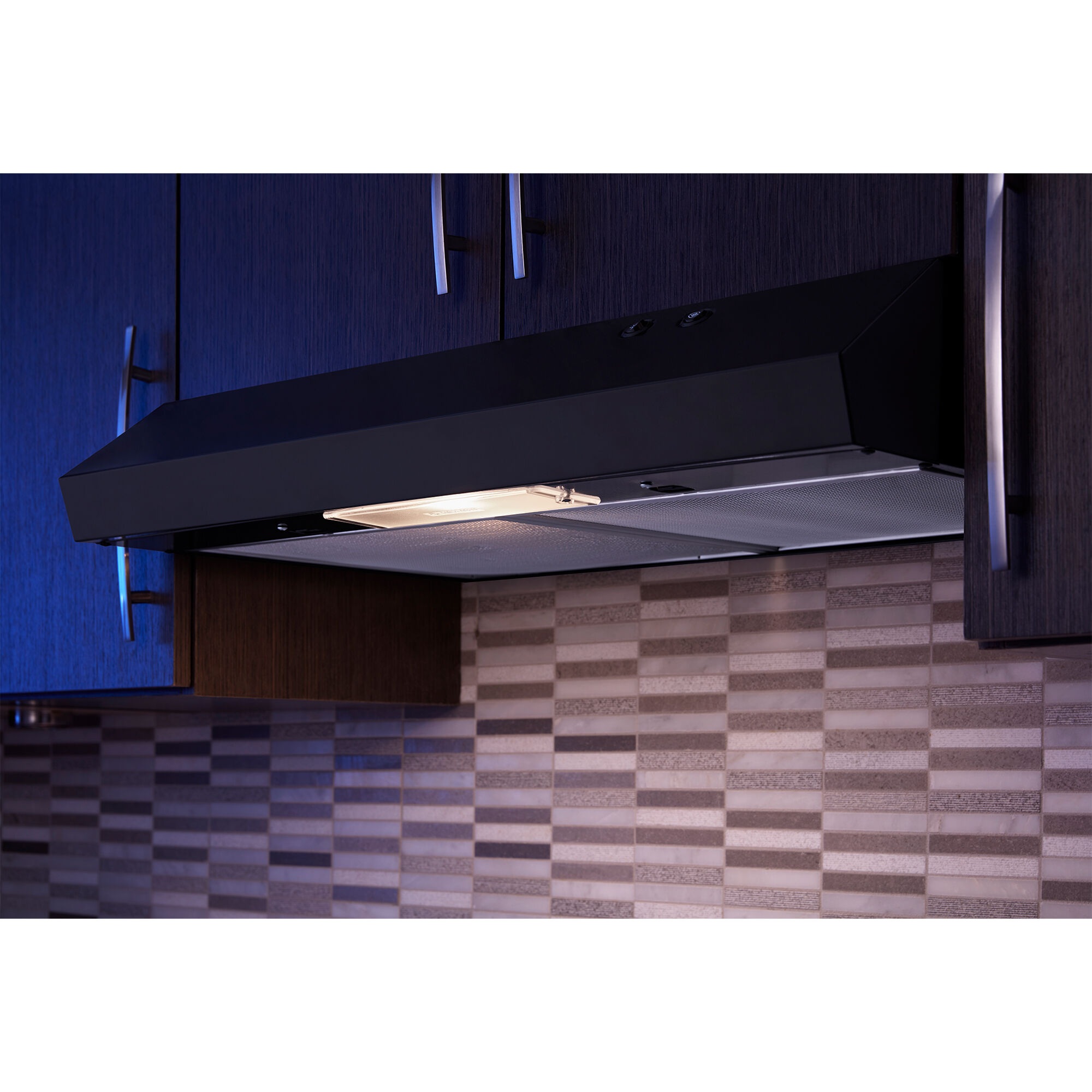 Whirlpool WVU17UC0JB range hood with LED light on, illuminating the cooktop surface below.