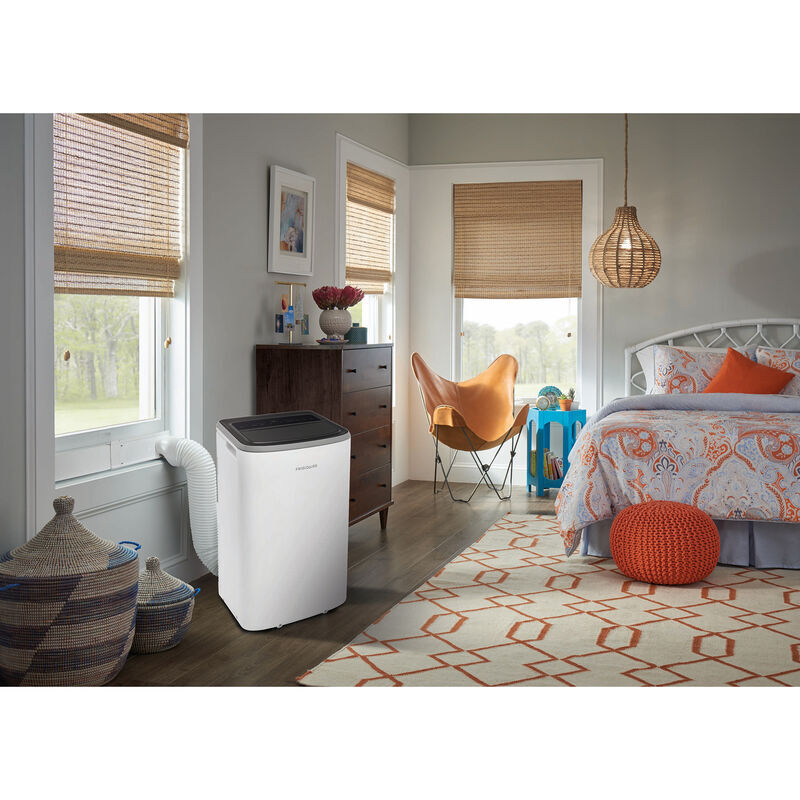 Frigidaire FHPW122AC1 Smart Portable Air Conditioner in white, shown in a room setting