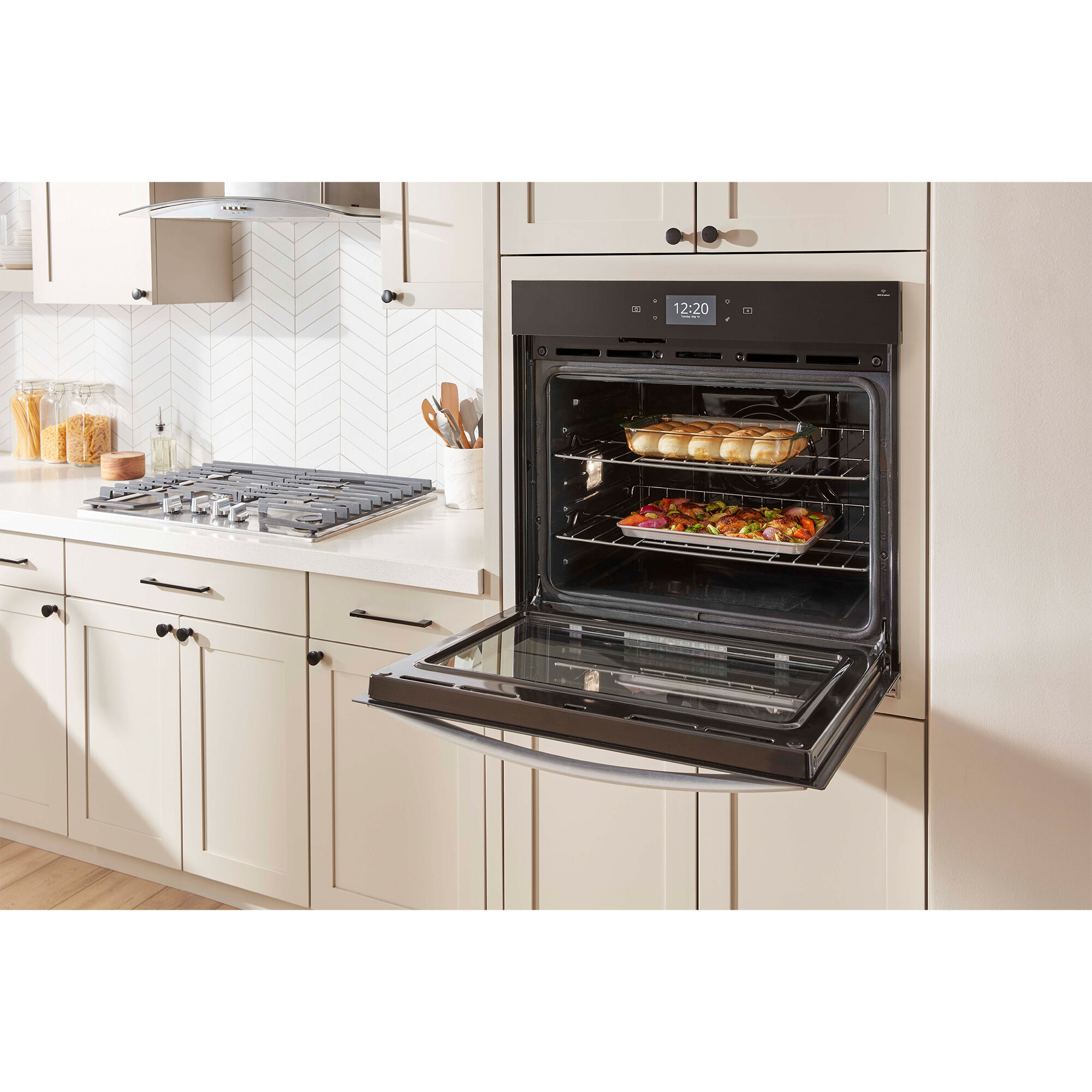 Interior of Whirlpool WOEC7027PZ wall oven showing True Convection fan and heating element with food cooking evenly on multiple racks.