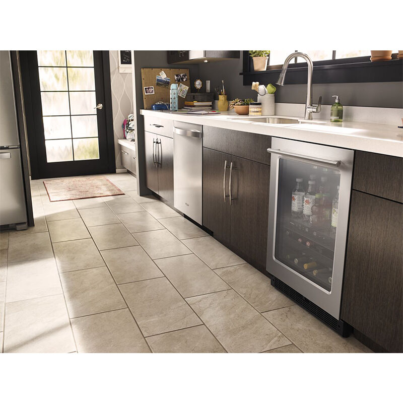 Whirlpool WUB35X24HZ stainless steel beverage center installed under a kitchen counter with stainless steel handle visible.