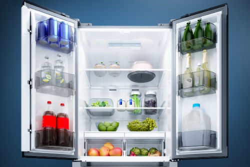 Midea MRF18B4AST French door refrigerator open, showing spacious interior filled with beverages, fresh fruits, vegetables, condiments, and door bins on both sides.