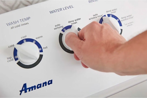 Close-up of Amana NTW4519JW washer control panel with easy-turn dials and clear cycle options, designed for straightforward operation.