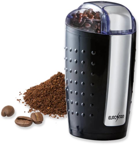 Stainless steel Eurostar coffee grinder model EG200B with transparent lid showing whole beans inside, pile of ground coffee beside it, and three whole coffee beans in foreground on white background.