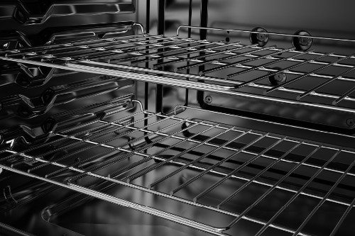 Midea oven interior showing two empty metal racks with a shiny finish.
