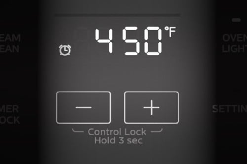 Midea oven control panel close-up showing 450 degrees Fahrenheit with plus and minus buttons and control lock instructions.