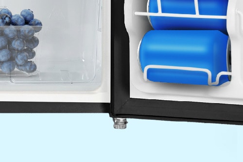 Close-up of compact refrigerator's adjustable leveling foot at the base, with crisper drawer and door storage visible above.