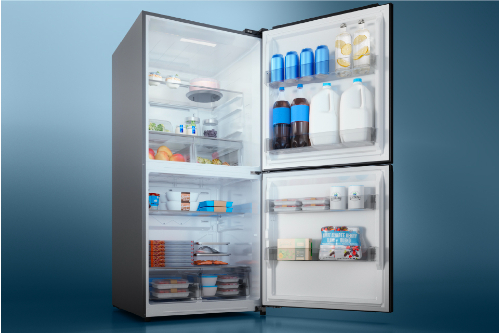 Open Midea 50/50 Flex refrigerator showing upper and lower compartments stocked with drinks, food, and freezer items.