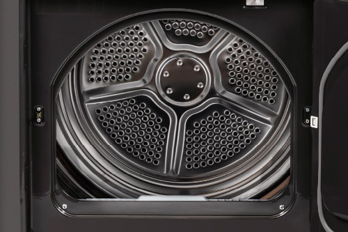 Interior view of Midea dryer drum showing stainless steel construction with perforated moisture sensors and raised tumbling pattern for gentle fabric care.