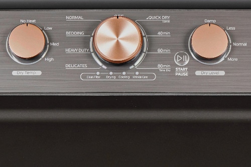 Close-up of dryer digital control panel showing rose gold colored cycle dial, LED display, and buttons for settings including Quick Dry, Time Dry, Air Fluff, Wrinkle Care, and Smart options.