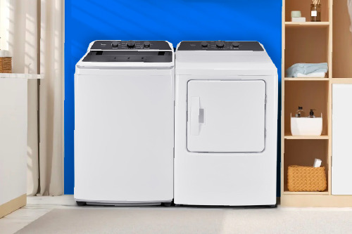 Midea white top load washer and matching dryer side by side in modern laundry room with blue accent wall and organized shelving