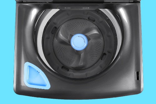 TOverhead view of Midea smart washer interior showing dark tub with perforated agitator, blue center accent, and built-in dispenser compartment.