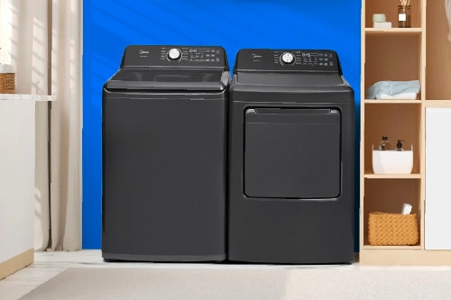 Midea metallic gray smart top load washer and matching dryer set side by side in modern laundry room with blue accent wall and organized shelving.
