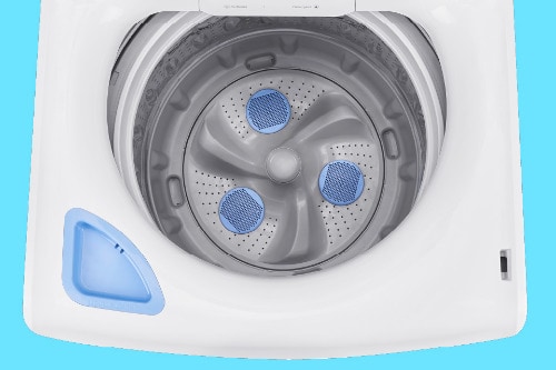 Top view of Midea washer showing impeller with three blue textured wash elements, perforated stainless steel basket, and built-in dispenser compartment