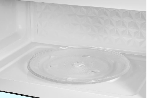 Interior view of microwave cavity showing clear glass turntable and white walls for easy cleaning and efficient cooking space in 1.7 cu. ft. capacity.
