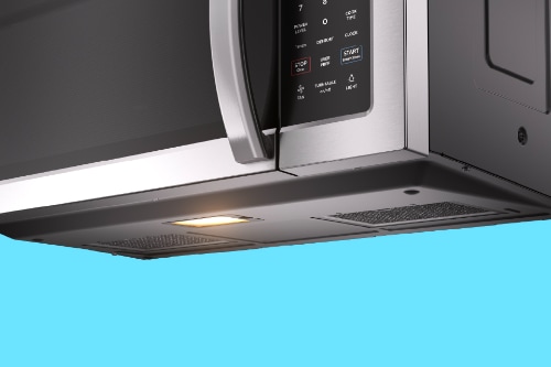 Bottom view of over-the-range microwave showing ventilation system with built-in fan, LED lighting, and grease filters for effective cooktop exhaust and illumination.