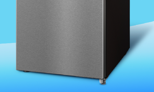 Close-up of stainless steel refrigerator bottom corner showing brushed metal finish, black side panel, and adjustable leveling foot against blue background.