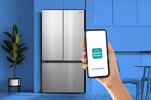 Midea Refrigerator Model MRF23I5AST in a kitchen with a hand holding a smartphone displaying the SmartHome app, indicating smart home connectivity.