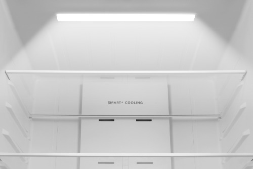 Close-up of the upper interior of Midea Refrigerator Model MRF23I5AST, showing bright LED lighting, glass shelving, and the Smart Cooling panel on the back wall.