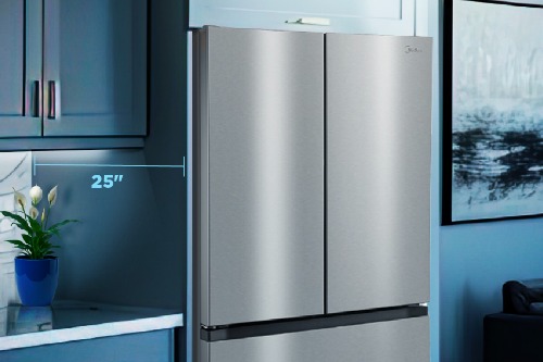 Midea MRF27I6BST stainless steel counter-depth French door refrigerator measuring 25 inches deep, shown installed in a modern blue kitchen setting.