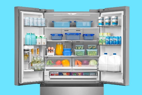 Midea 32 cu. ft. French Door Refrigerator model MRF32I6BST shown open, revealing organized storage with beverages, produce, and containers neatly arranged on adjustable shelves and door bins against a bright blue background.