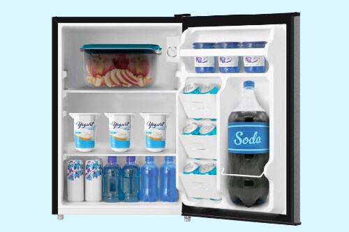 nterior view of Midea 2.7 cubic foot compact refrigerator with door open showing organized storage with yogurt containers, beverages, water bottles, and freezer compartment with food storage.
