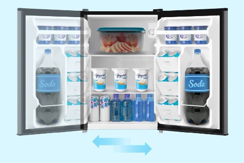 Midea compact refrigerator with reversible door shown open displaying interior storage, with blue arrows below indicating door can swing either direction for flexible placement.