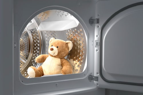 Interior view of Midea gas dryer showcasing spacious 7.0 cu. ft. stainless steel drum with perforated pattern for optimal airflow, open door revealing large cap