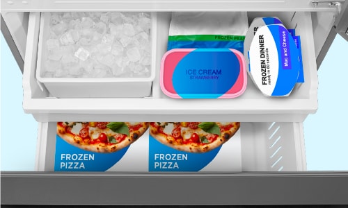 Midea refrigerator's frost-free bottom freezer drawer with ice bin, strawberry ice cream, frozen peas, and frozen pizzas, demonstrating organized storage without frost buildup.