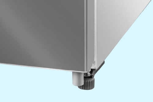 Close-up of Midea refrigerator's adjustable leveling leg at bottom corner, showing screw mechanism for height adjustment on light blue background.