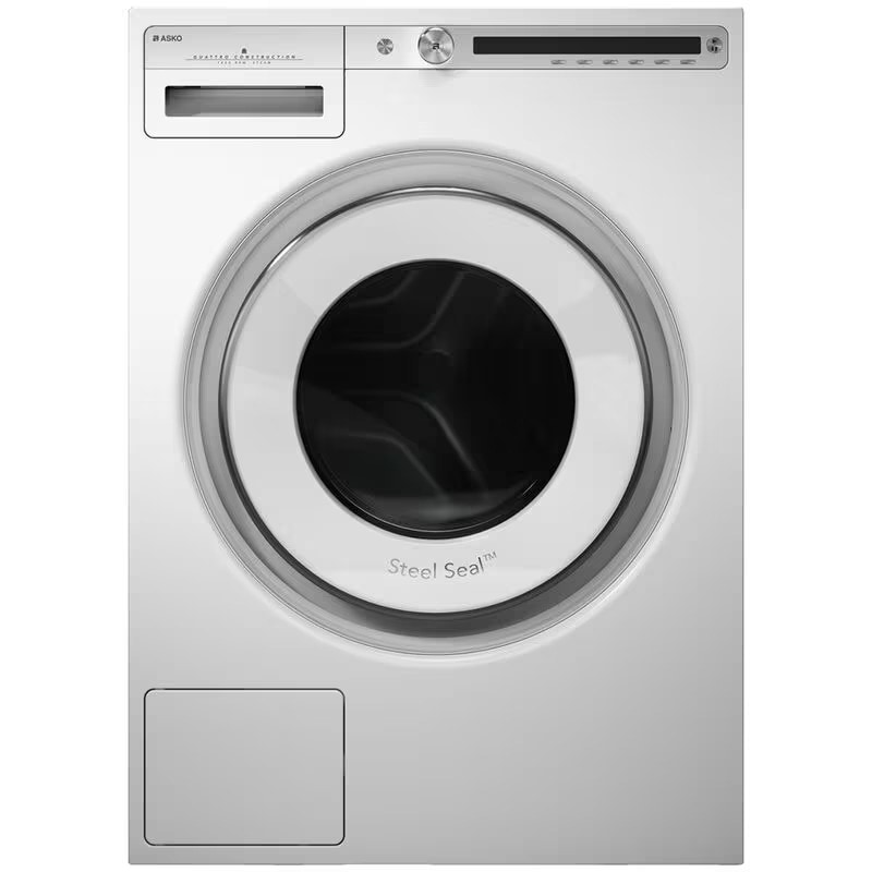 Asko front load washing machine in white finish featuring Steel Seal drum door with chrome accents, top-mounted control panel with digital display, detergent dispenser drawer, and lower access panel for modern laundry room installation. 