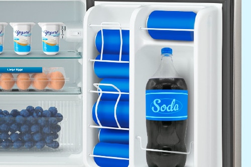 Interior door storage of compact refrigerator showing multiple adjustable shelves holding 2-liter soda bottle, tall bottle holders, and beverage cans with efficient organization.