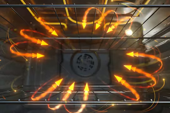 Interior oven view demonstrating air cooking technology with animated orange airflow arrows showing circular heat distribution pattern from rear convection fan throughout oven cavity for even cooking, Whirlpool range.