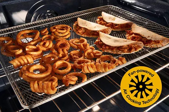 Interior oven view of Whirlpool WFGS5030RS showing air cooking technology with wire rack holding curly fries, onion rings, and chicken tenders with melted cheese, yellow badge highlighting fan-powered air cooking technology feature.