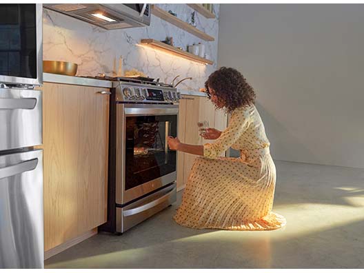 Woman Knocking on LG Oven to Turn Light On