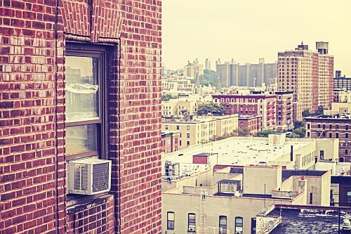 Back view of Air Conditioner installed in window of a high rise building