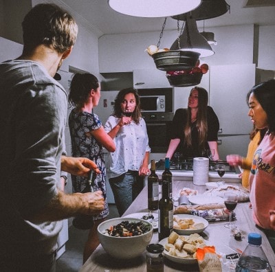 Friends Gathered Around Kitchen Island