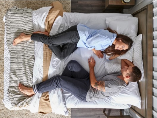 Overhead View of Smiling Couple in Bed